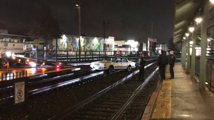 Car gets stuck on train tracks, rail service delayed