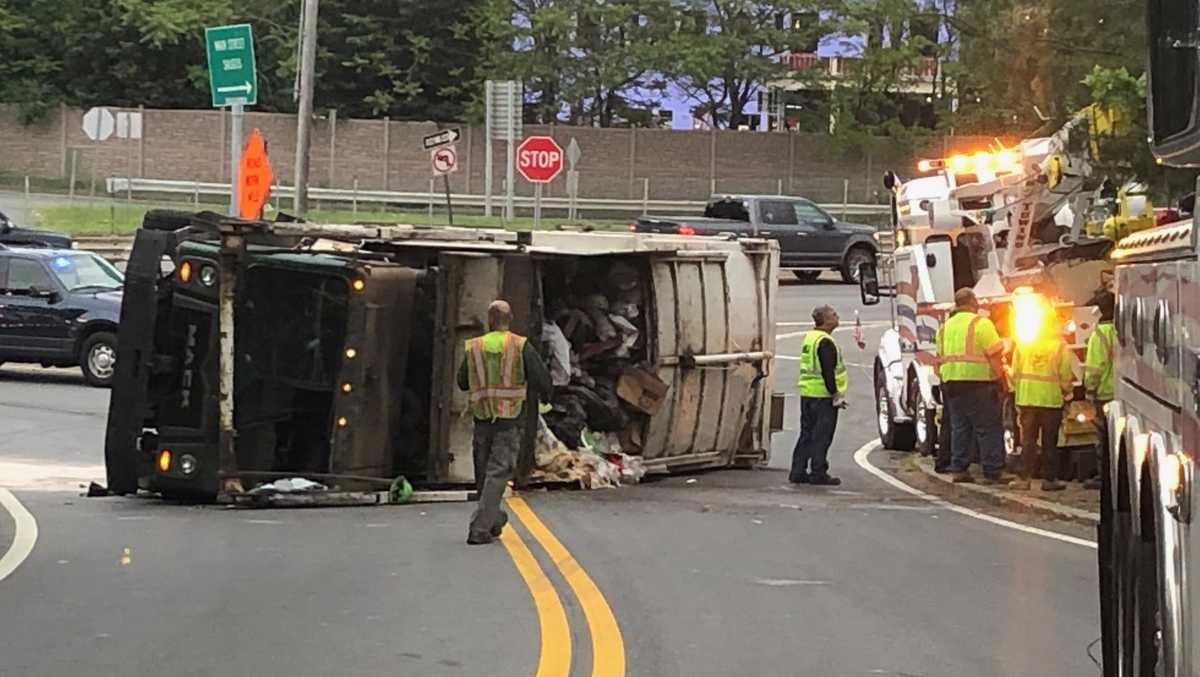 Trash truck rolls over in Saugus dumping debris on roadway