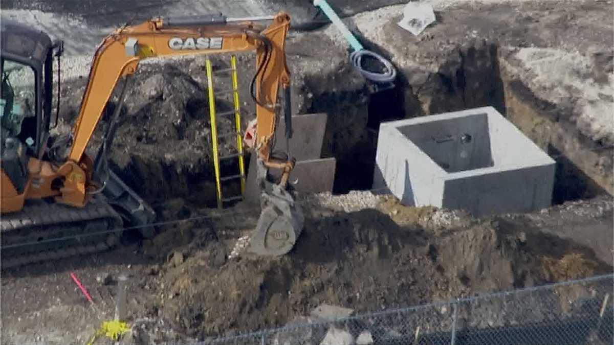 Construction worker rescued after being buried waist-deep in trench