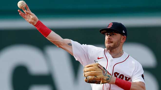 Trevor Story of the Boston Red Sox walks through the batting