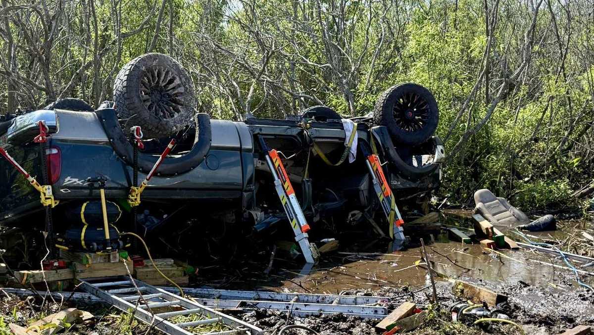 Two people rescued from flipped truck sinking into mud