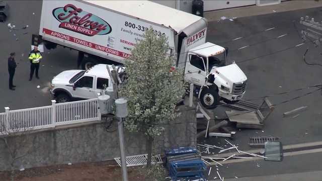 Driver charged in crash that left box truck dangling over wall - Vimarsana News