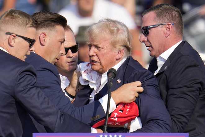 Donald Trump was whisked off the stage at a rally in Butler, Pennsylvania after apparent gunshots rang through the crowd. He quickly ducked behind the podium as agents from his protective detail rushed the stage and screams rang out from the crowd