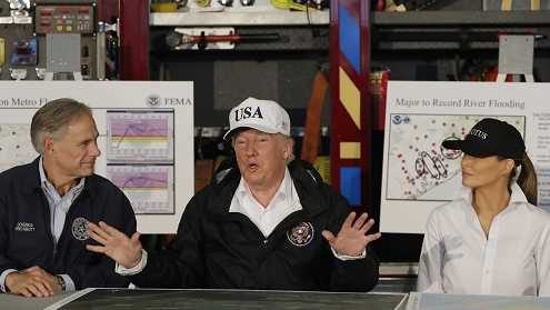 President Donald Trump, flanked by Texas Gov. Greg Abbott and first lady Melania Trump speaks during a briefing on Harvey relief efforts, Tuesday, Aug. 29, 2017, at Firehouse 5 in Corpus Christi, Texas.