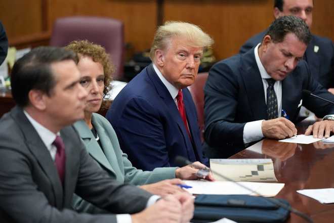Former&#x20;President&#x20;Donald&#x20;Trump&#x20;sits&#x20;at&#x20;the&#x20;defense&#x20;table&#x20;with&#x20;his&#x20;legal&#x20;team&#x20;in&#x20;a&#x20;Manhattan&#x20;court,&#x20;Tuesday,&#x20;April&#x20;4,&#x20;2023,&#x20;in&#x20;New&#x20;York.&#x20;Trump&#x20;is&#x20;appearing&#x20;in&#x20;court&#x20;on&#x20;charges&#x20;related&#x20;to&#x20;falsifying&#x20;business&#x20;records&#x20;in&#x20;a&#x20;hush&#x20;money&#x20;investigation,&#x20;the&#x20;first&#x20;president&#x20;ever&#x20;to&#x20;be&#x20;charged&#x20;with&#x20;a&#x20;crime.
