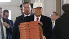 Republican presidential candidate former President Donald Trump arrives to deliver pizza to fire fighters at Waukee Fire Department in Waukee, Iowa on Sunday.