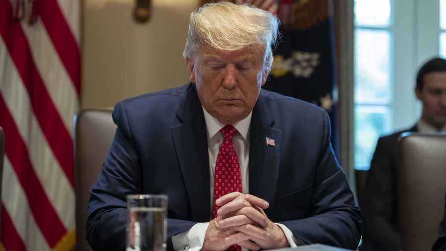 President Donald Trump prays during a cabinet meeting at the White House, Tuesday, Nov. 19, 2019, in Washington.