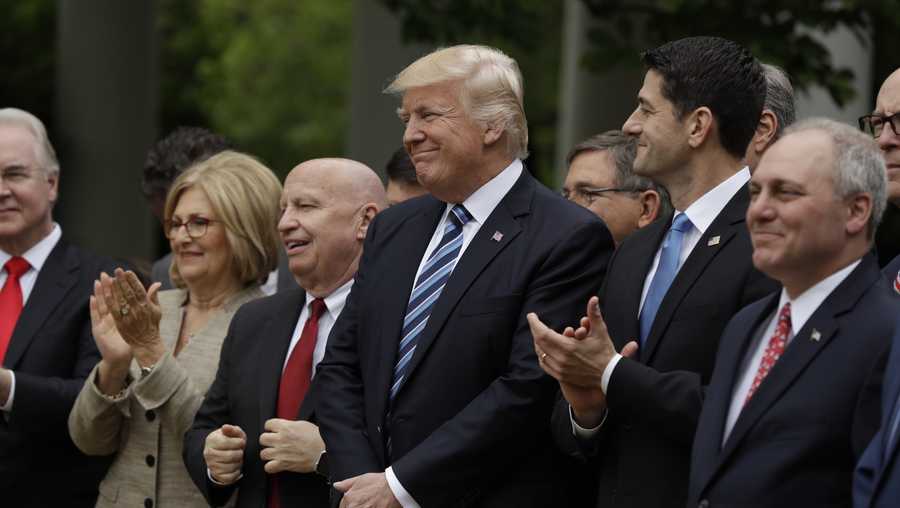 President Donald Trump, flanked by House Ways and Means Committee Chairman Rep. Kevin Brady, R-Texas, and House Speaker Paul Ryan of Wis., are seen in the Rose Garden of the White House in Washington, Thursday, May 4, 2017, after the House pushed through a health care bill.