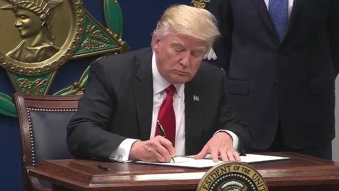 President Donald Trump signing
