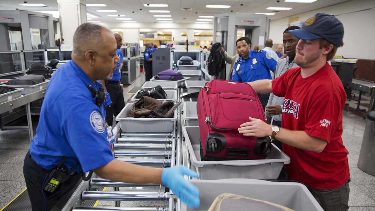 TSA workers face reality of working without pay as passengers unaware of the shutdown see long lines