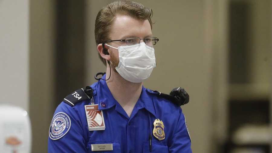 an officer wears a mask at the airport amid the coronavirus pandemic