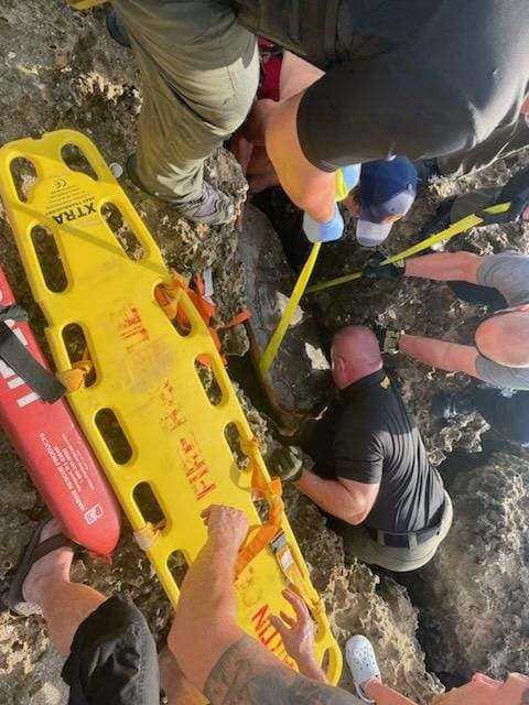 First responders help free loggerhead turtle stuck on rocky shoreline