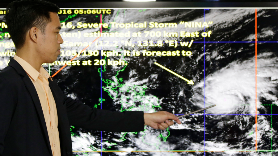 Weather specialist Benison Estareja shows the track of Tropical Storm Nock-Ten during a press conference in Quezon city, north of Manila, Philippines on Friday, Dec. 23, 2016. A severe tropical storm has gained strength as it moves closer to the Philippines and may intensify further into a typhoon, bringing moderate to heavy rains and blustery weather on Christmas Day, the biggest holiday in the predominantly Roman Catholic nation, weather forecasters said. (AP Photo/Aaron Favila)