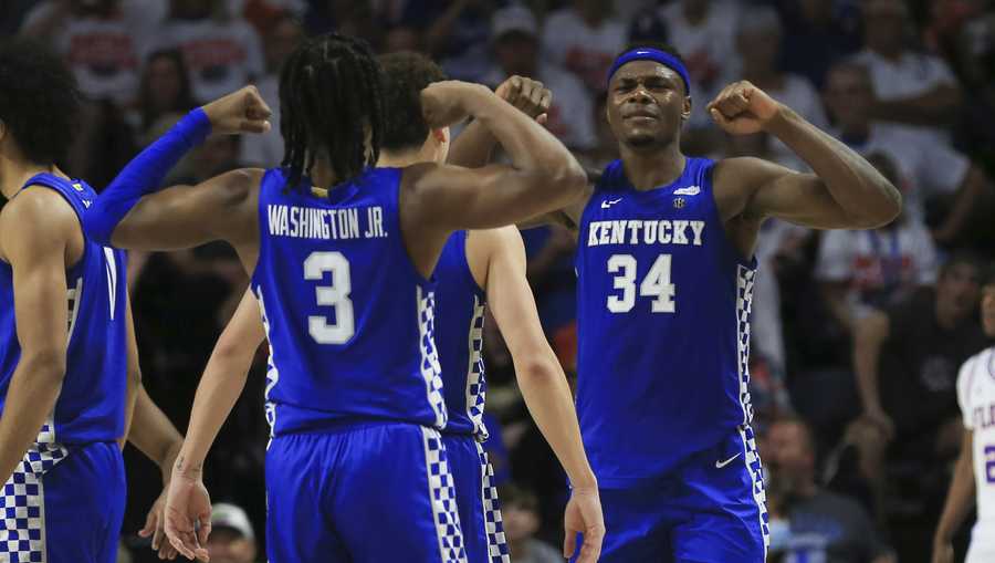 Kentucky forward Oscar Tshiebwe (34) and guard TyTy Washington Jr. (3) celebrate after a play against Florida during the second half of an NCAA college basketball game Saturday, March 5, 2022, in Gainesville, Fla. (AP Photo/Matt Stamey)