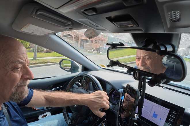 Retiree Stu Goldberg prepares to pick up passengers for Uber near Plainview, N.Y., on Tuesday, March 31, 2026.