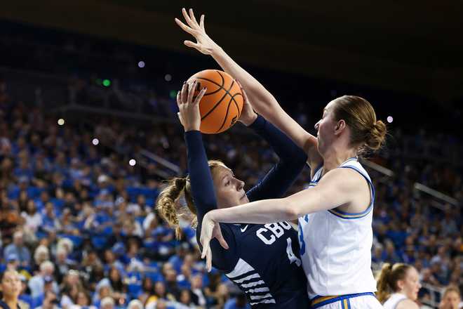 California Baptist guard Reyleigh Hess, left, drives against UCLA forward Amanda Muse, right, during the first half in the first round of the NCAA college basketball tournament, Saturday, March 21, 2026.