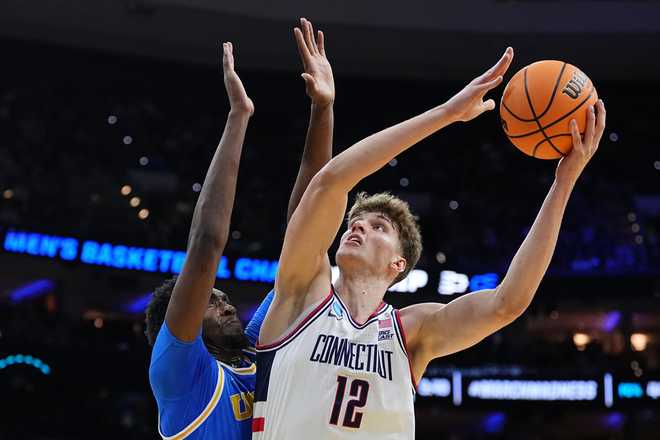 UConn&amp;apos;s Eric Reibe (12) goes up to shoot against UCLA&amp;apos;s Xavier Booker during the first half in the second round of the NCAA college basketball tournament, Sunday, March 22, 2026.