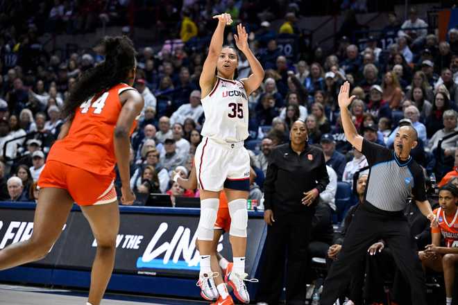 UConn guard Azzi Fudd (35) shoots a 3-point basket against Syracuse during the first half in the second round of the NCAA college basketball tournament, Monday, March 23, 2026, in Storrs, Conn.