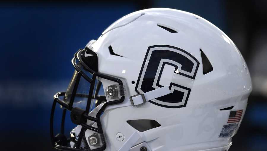 In this Sept. 7, 2019, file photo, Connecticut football helmet rests on the sideline during an NCAA college football game in East Hartford, Conn. UConn has canceled its 2020-2021 football season, becoming the first FBS program to suspend football because of the coronavirus pandemic.