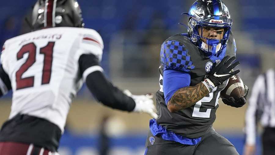 Kentucky running back Chris Rodriguez Jr. carries the ball as South Carolina's Shilo Sanders defends during the first half of an NCAA college football game Saturday, Dec. 5, 2020, in Lexington, Ky
