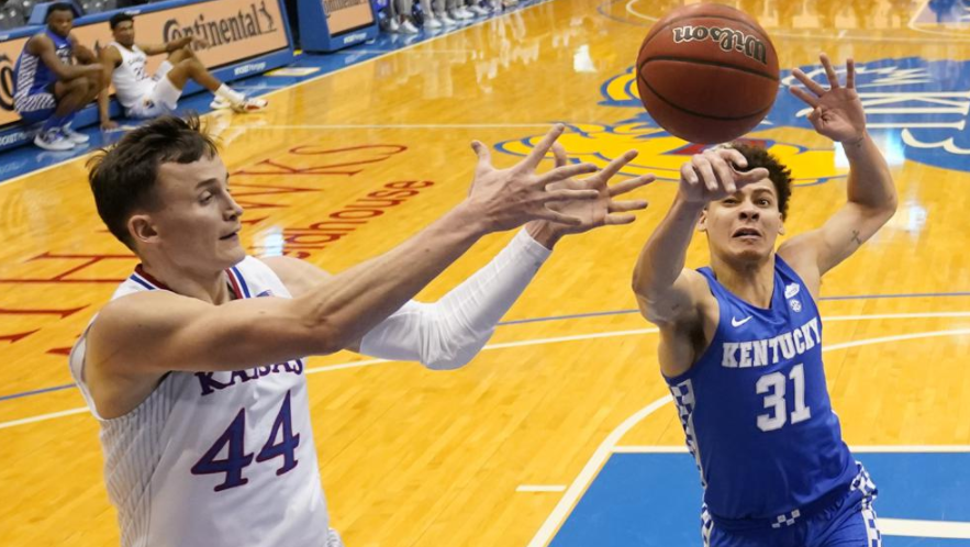 kentucky guard kellan grady (31) blocks a pass intended for kansas forward mitch lightfoot (44) during the first half of an ncaa college basketball game saturday, jan. 29, 2022, in lawrence, kan. (ap photo/charlie riedel)