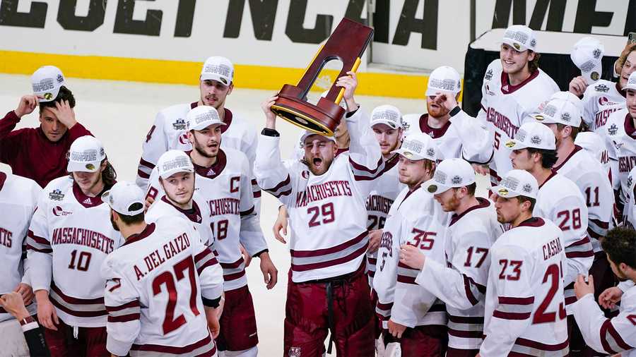 Massachusetts' George Mika (29) holds the NCAA trophy over his head as he skates with the team to celebrate a 5-0 win over St. Cloud State in the NCAA men's Frozen Four hockey championship game in Pittsburgh, Saturday, April 10, 2021. (AP Photo)