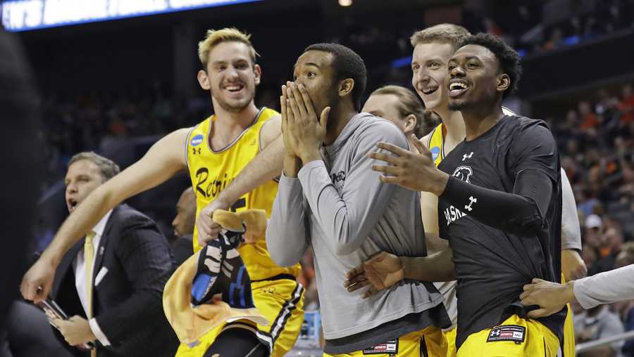 UMBC players celebrate a teammate's basket against Virginia during the second half of a first-round game in the NCAA men's college basketball tournament in Charlotte, N.C., Friday, March 16, 2018.