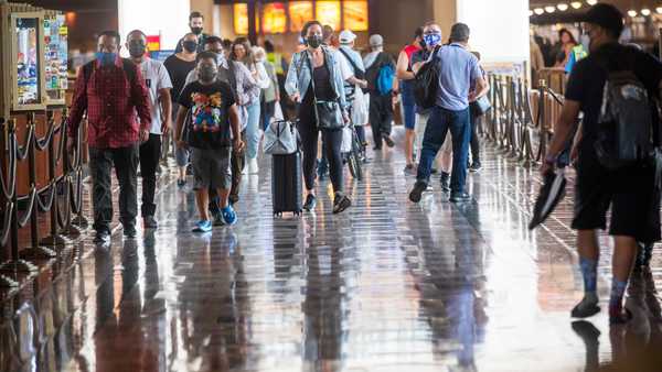 LOS ANGELES, CA - JUNE 29: Wearing face masks, people walk through Union Station  on Tuesday, June 29, 2021 in Los Angeles, CA.
