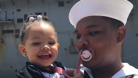 Young girl welcomes home Navy father