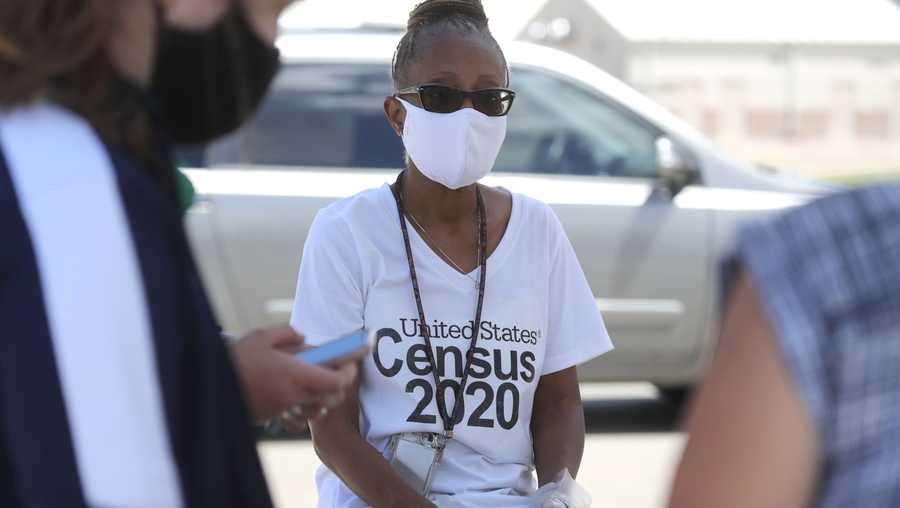 Amid concerns of the spread of COVID-19, census worker Jennifer Pope wears a mask and sits by ready to help at a U.S. Census walk-up counting site set up for Hunt County in Greenville, Texas, Friday, July 31, 2020.