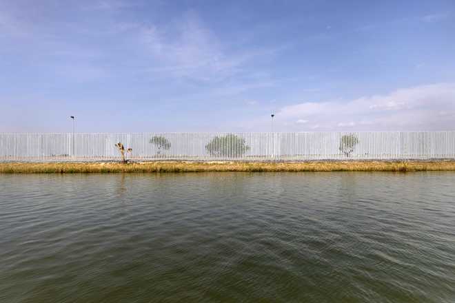 A&#x20;privately-funded&#x20;border&#x20;fence&#x20;stands&#x20;along&#x20;the&#x20;bank&#x20;of&#x20;the&#x20;Rio&#x20;Grande&#x20;at&#x20;the&#x20;U.S.-Mexico&#x20;Border&#x20;on&#x20;March&#x20;23,&#x20;2021&#x20;near&#x20;Mission,&#x20;Texas.
