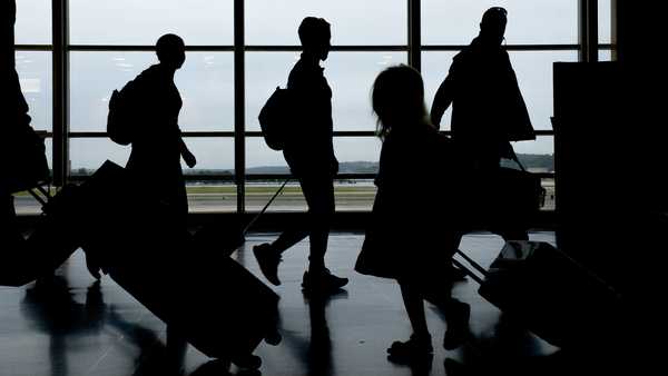 Travelers walk through Ronald Reagan National Airport (DCA) in Arlington, Virginia, U.S., on Tuesday, May 25, 2021.