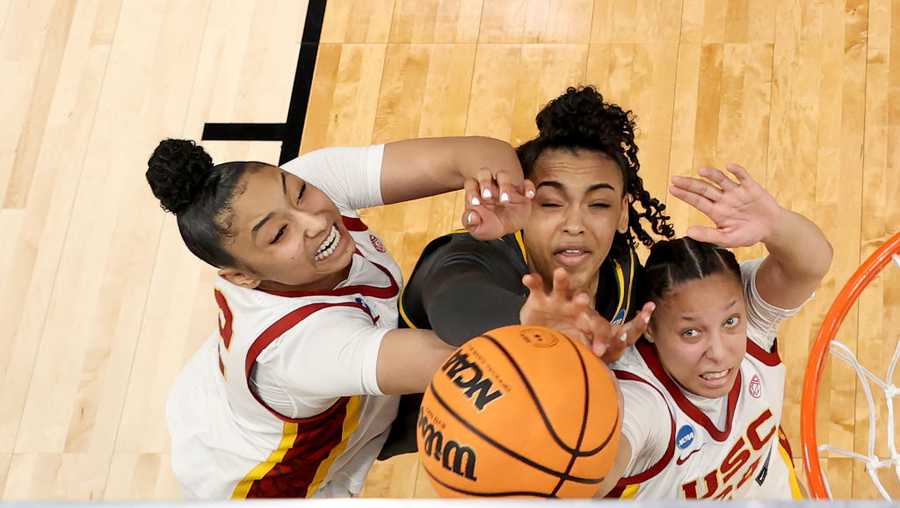 PORTLAND, OREGON - MARCH 30: JuJu Watkins #12 of the USC Trojans, Bella Fontleroy #22 of the Baylor Lady Bears and Kaitlyn Davis #24 of the USC Trojans rebound in the Sweet 16 round of the NCAA Women&apos;s Basketball Tournament at Moda Center on March 30, 2024 in Portland, Oregon.