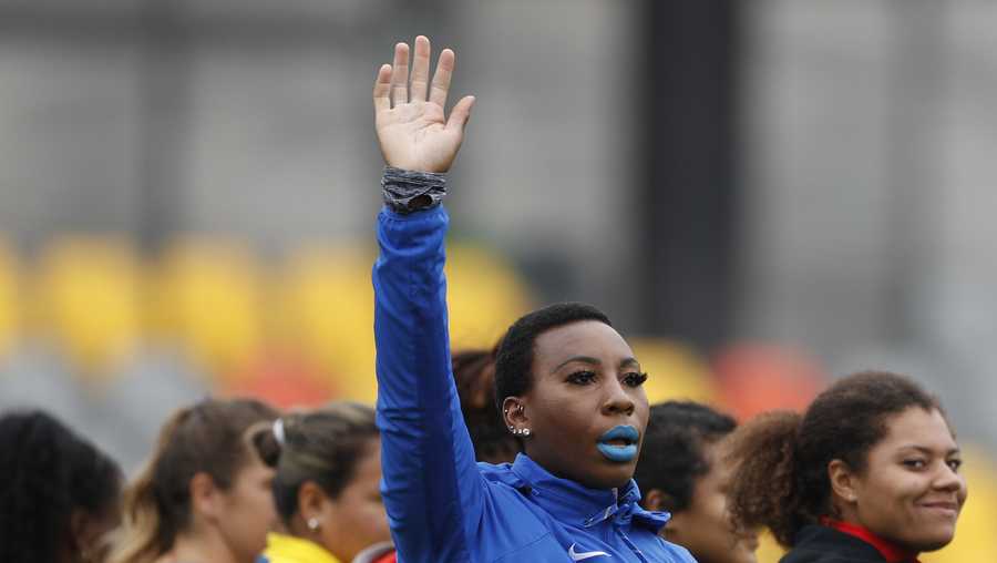 In this Aug. 10, 2019, file photo, Gwendolyn "Gwen" Berry of the United States waves as she is introduced at the start of the women's hammer throw final, during athletics competition at the Pan American Games in Lima, Peru.
