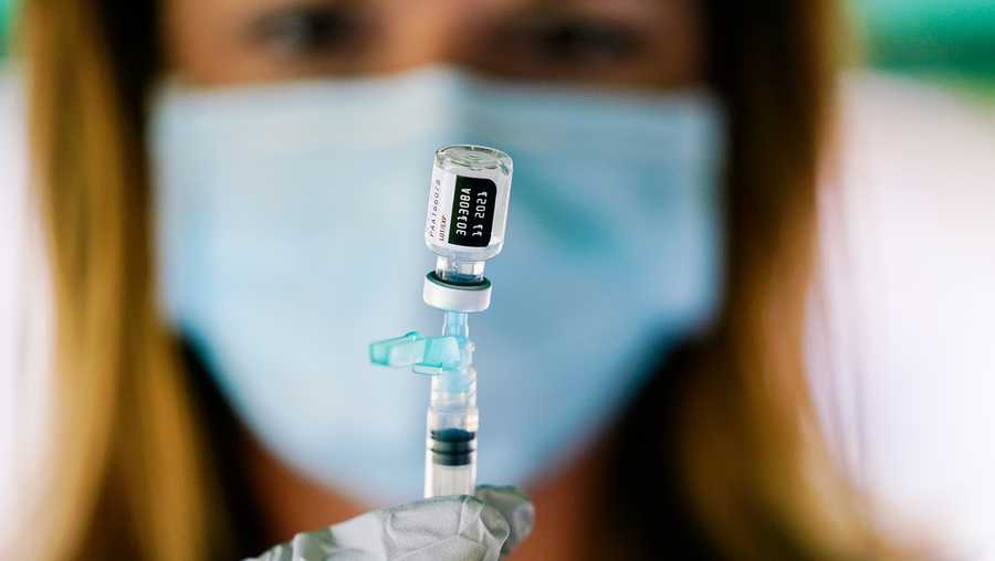 In this Sept. 14, 2021, file photo, a syringe is prepared with the Pfizer COVID-19 vaccine at a clinic at the Reading Area Community College in Reading, Pa. COVID-19 deaths and cases in the U.S. have climbed back to where they were over the winter, wiping out months of progress and potentially bolstering President Joe Biden’s case for sweeping new vaccination requirements.
