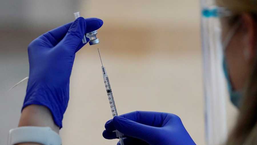 A nurse draws Pfizer's coronavirus vaccine into a syringe Monday, Dec. 14, 2020, at Integris Baptist Medical Center in Oklahoma City. (AP Photo/Sue Ogrocki)