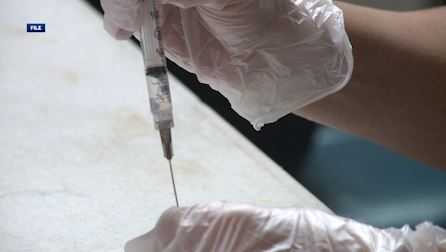 a medical worker prepares another covid 19 vaccine