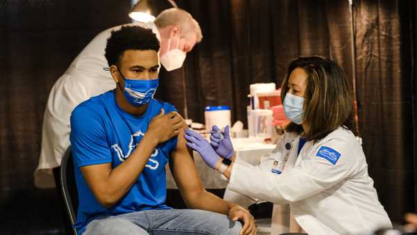 A group of teenagers serving as 'COVID-19 Student Ambassadors' joined Michigan Gov. Gretchen Whitmer to receive a dose of the Pfizer Covid vaccine at Ford Field during an event to promote and encourage residents to go and get their vaccines on April 6, 2021 in Detroit.