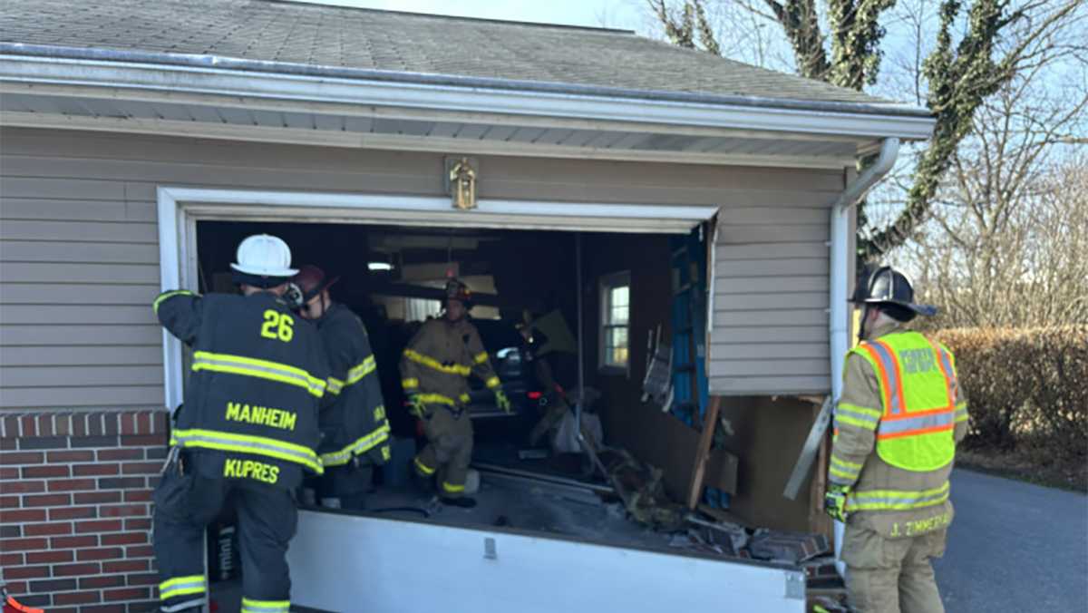 Driver moving garbage cans crashes through back of garage, police say
