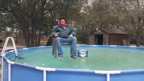 Tim McCoy on his pool with a case of beer in his original viral photo. (Source: Dana Kimrey)