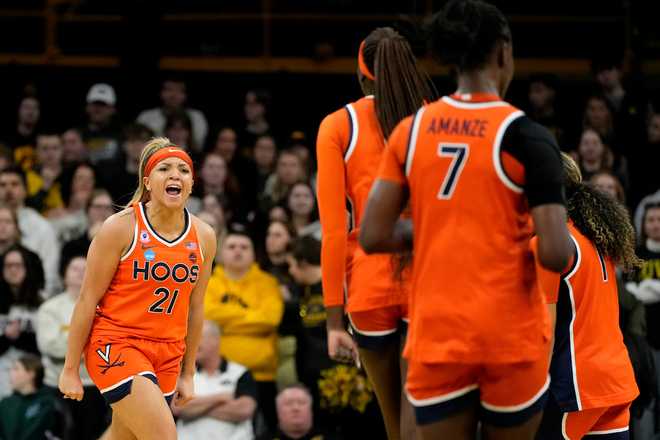 Virginia guard Kymora Johnson (21) celebrates after making a three-point basket during the first half against Iowa in the second round of the NCAA college basketball tournament, Monday, March 23, 2026, in Iowa City, Iowa.