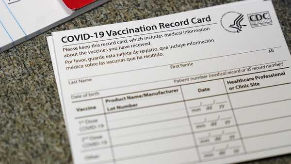 FILE - In this Dec. 24, 2020, file photo, a COVID-19 vaccination record card is shown at Seton Medical Center in Daly City, Calif. Los Angeles leaders are poised to enact one of the nation's strictest vaccine mandates, a sweeping measure that would require the shots for everyone entering a bar, restaurant, nail salon, gym or even a Lakers game. The City Council on Wednesday, Oct. 6, 2021, is scheduled to consider the proposal and most members have said they support it as a way of preventing further COVID-019 surges.