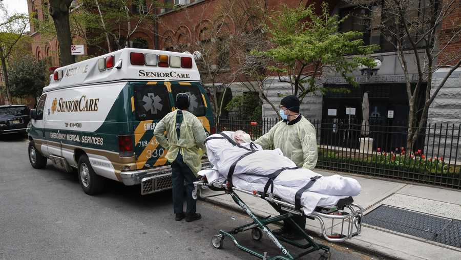 A patient is wheeled out of Cobble Hill Health Center by emergency medical workers, Friday, April 17, 2020, in the Brooklyn borough of New York.
