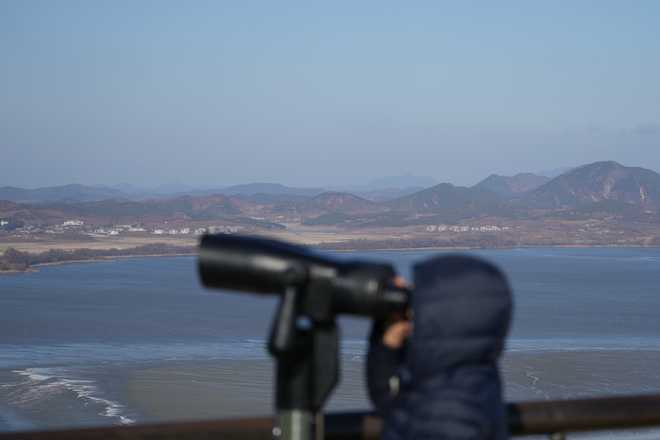 A visitor watches North Korean side from the unification observatory in Paju, South Korea,  on Dec. 25, 2025.
