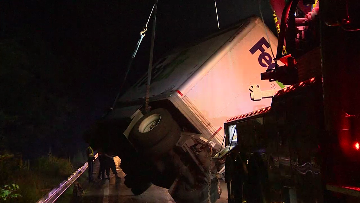 Driver of truck that rolled over says something thrown at windshield