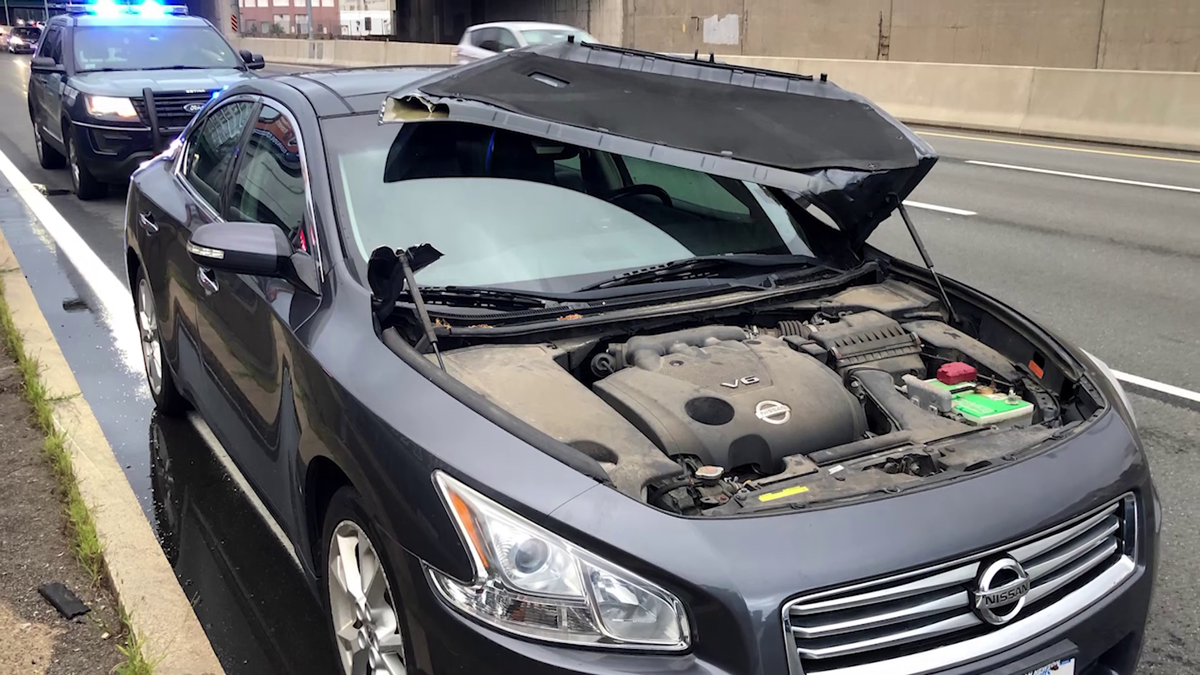 Young driver frightened after hood opens on the road