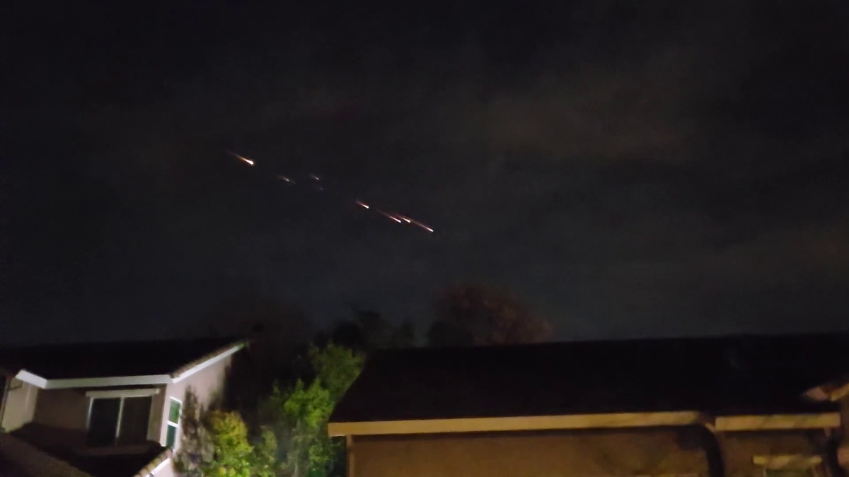 Bright orbs of light streak across the northern California sky