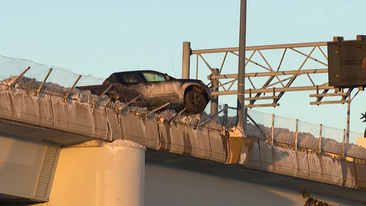 Truck left partially dangling over Interstate 93 overpass in Boston after crash