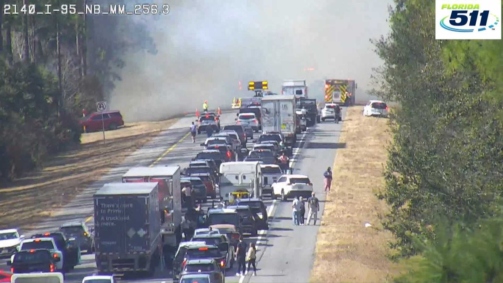 Emergency vehicles and smoke visible on Interstate 95 in Port Orange, Florida, due to a fire.
