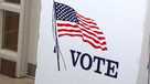 A voting booth shows the American flag.